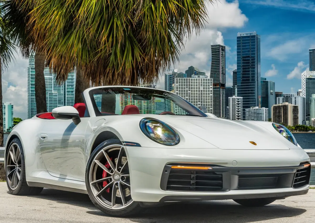 White Porsche 911 Carrera S Cabriolet beside the Miami skyline